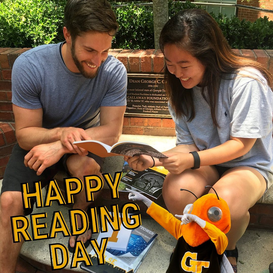 One woman and one man reading a book. Buzz in the corner point to a text that reads: Happy Reading Day.